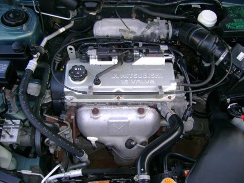 Мицубиси каризма двигатели. Двигатель Митсубиси Каризма 1.6. Двигатель Mitsubishi Carisma 2003 1.6. Mitsubishi Carisma 2002 мотор 1.8. Мотор Митсубиси Каризма 1.6 2003 год.
